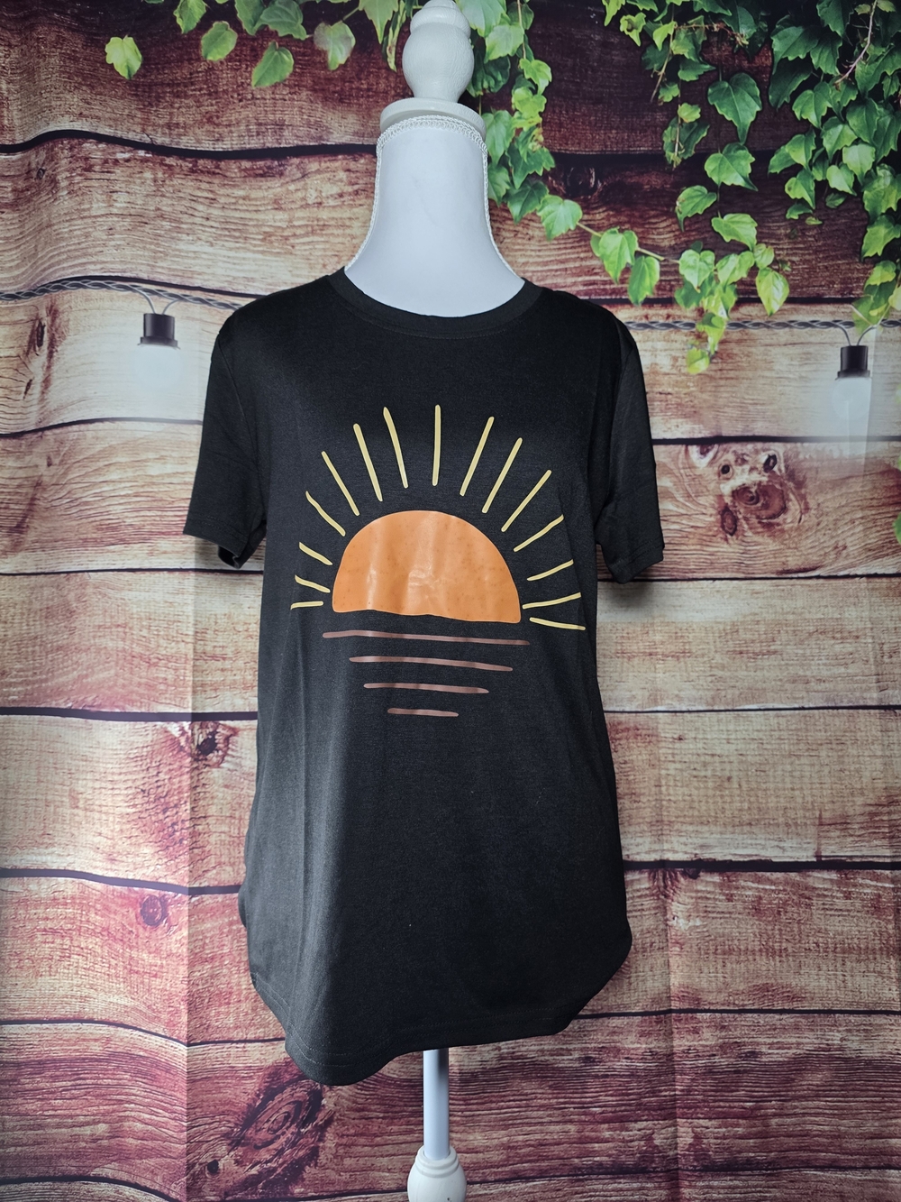 NWOT Women's Black Graphic Tee with Orange Sun Design